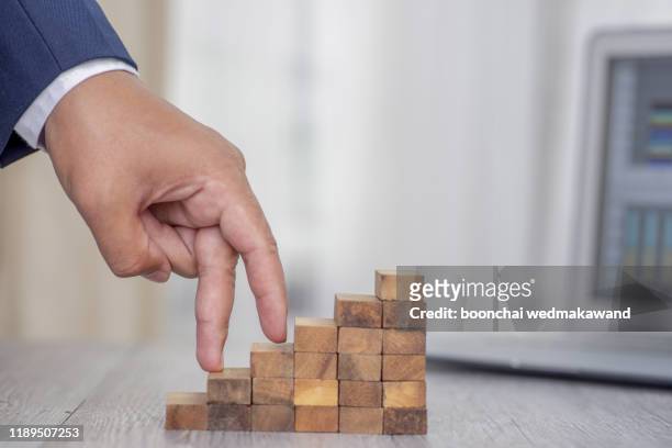 fingers walking up blocks as stairs for concept about business and climbing up in seniority.  g - career path stock pictures, royalty-free photos & images