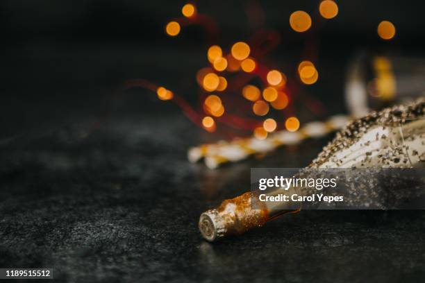 closeup golden sparky festive botlle in black - glamour stock pictures, royalty-free photos & images