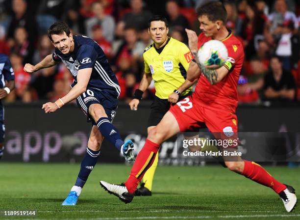 Robbie Kruse of the Victory shoots for goal pass Michael Jakobson of Adelaide United during the round 7 A-League match between Adelaide United and...