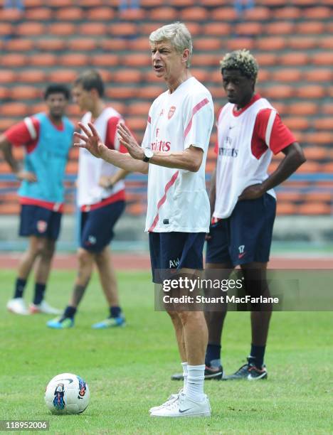 Arsenal manager Arsene Wenger oversees a training session at Shah Alam Stadium on July 12, 2011 in Shah Alam, Malaysia.