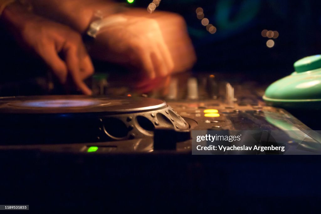 DJ playing techno music at night, turning and spinning, Vagator, Goa