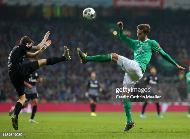 Benito Raman of FC Schalke 04 battles for possession with Sebastian Langkamp of SV Werder Bremen during the Bundesliga match between SV Werder Bremen...