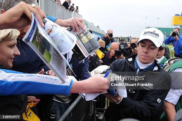 Rory McIlroy of Northern Ireland signs autographs for fans during the final practice round during The Open Championship at Royal St. George's on July...