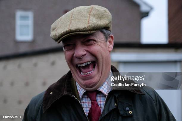 Brexit Party leader Nigel Farage reacts as he goes door to door campaigning in Hartlepool during the Brexit Party general election campaign tour on...