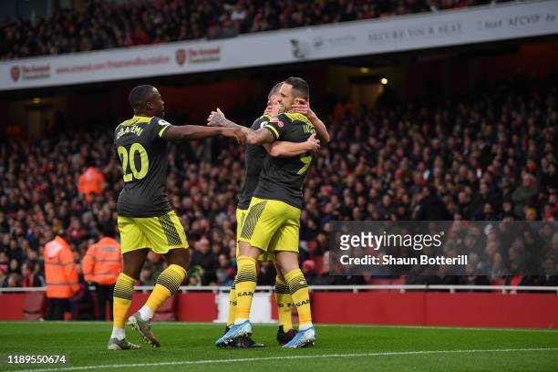 Danny Ings of Southampton celebrates with teammates after scoring his team's first goal during the Premier League match between Arsenal FC and...