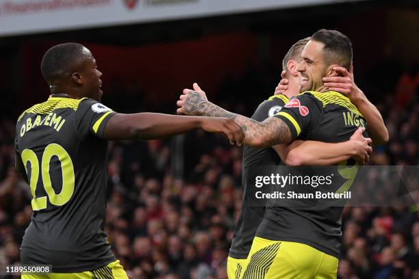 Danny Ings of Southampton celebrates with Michael Obafemi and James Ward-Prowse after scoring his team's first goal during the Premier League match...