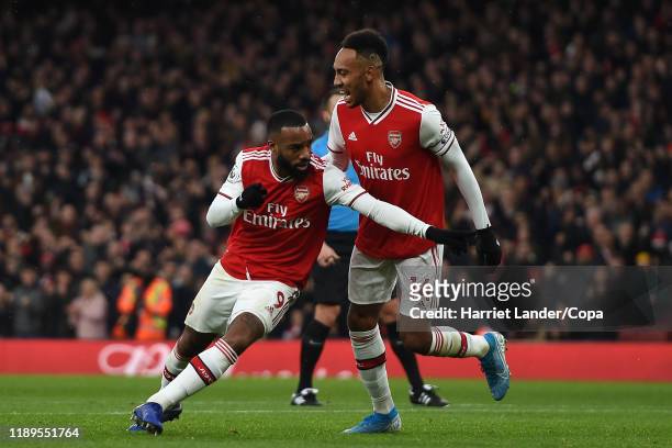 Alexandre Lacazette of Arsenal celebrates with teammate Pierre-Emerick Aubameyang after scoring his team's first goal during the Premier League match...