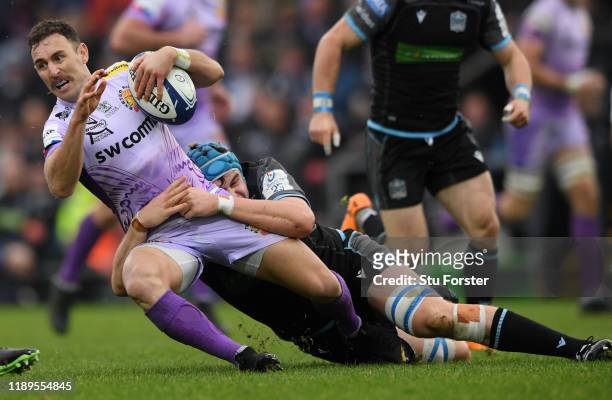 Chiefs player Nic White is tackled by Scott Cummings of Glasgow during the Heineken Champions Cup Round 2 match between Exeter Chiefs and Glasgow...