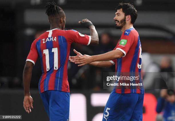 James Tomkins of Crystal Palace celebrates with teammate Wilfried Zaha after scoring his team's first goal which is later disallowed by VAR during...