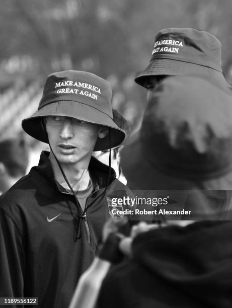 Group of high school students on a field trip to Washington, D.C., several wearing 'Make American Great Again' hats, visit Arlington National...