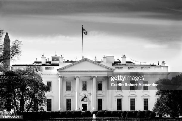 The American flag flies over the North Portico of the White House in Washington, D.C.