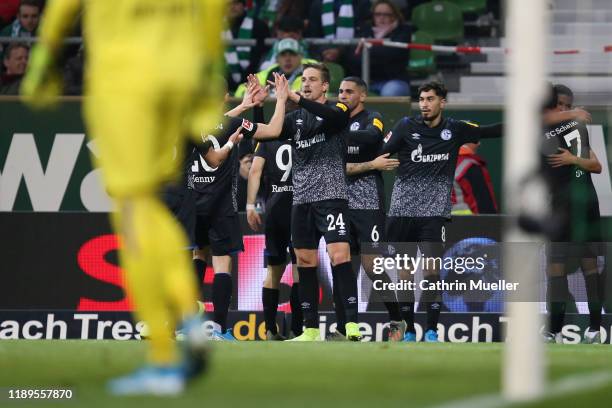Bastian Oczipka of FC Schalke 04 celebrates with teammates after his team's first goal during the Bundesliga match between SV Werder Bremen and FC...