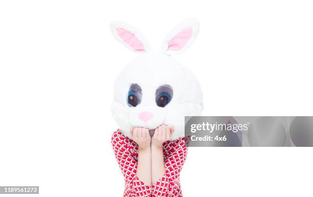 One person / front view / waist up of 18-19 years old adult beautiful blond hair caucasian female / young women teenage girls standing wearing dress / mask - disguise / costume who is humor / cool attitude / wearing a rabbit mask