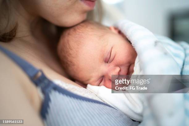 baby sleeping with his mother - baby blanket stock pictures, royalty-free photos & images