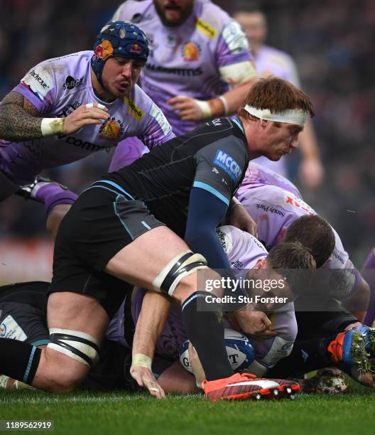 Chiefs player Jonny Hill dives over to score the first Exeter try despite the attentions of Rob Harley of Glasgow during the Heineken Champions Cup...