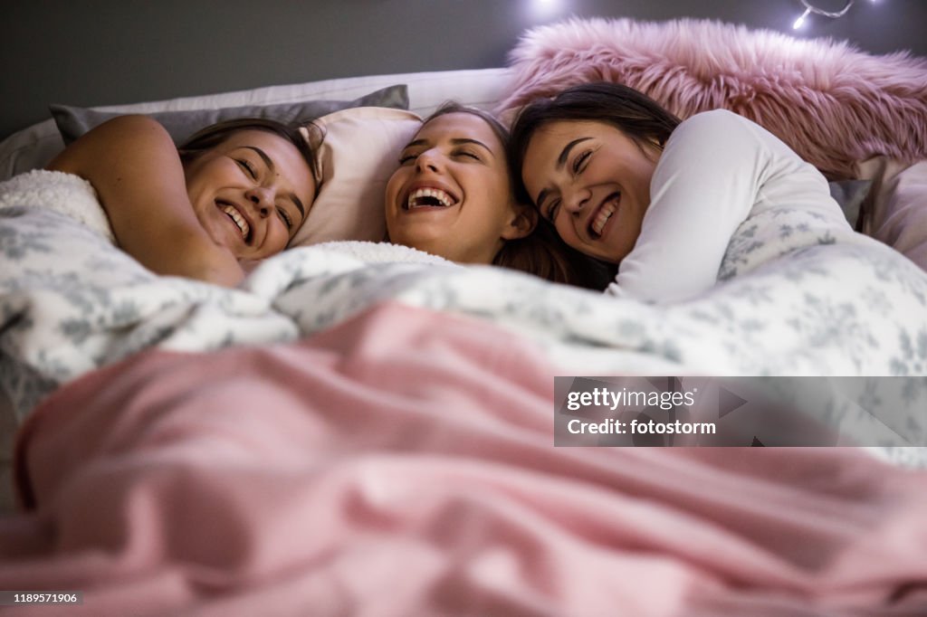 Girlfriends having a laugh on a sleepover