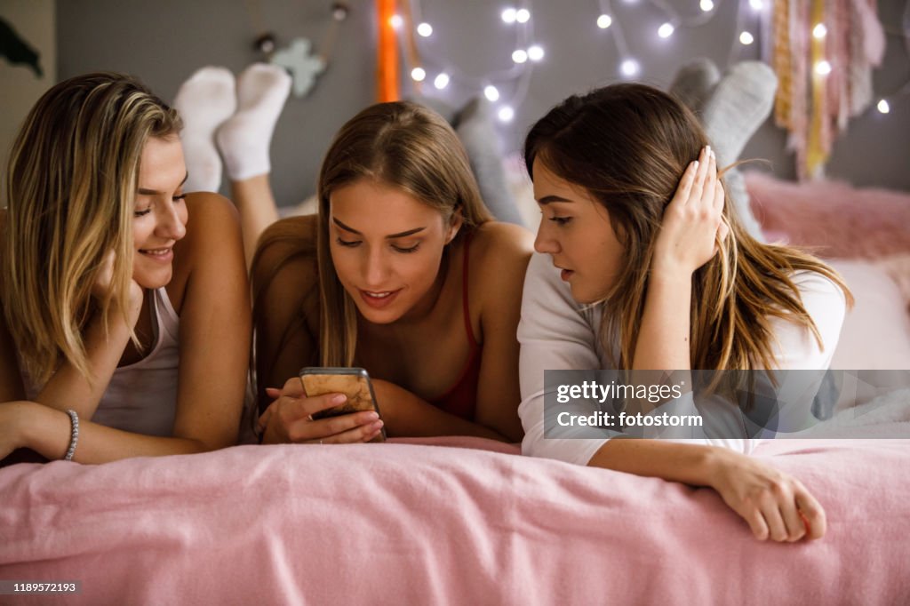 Female Reminiscing Girlfriends Reminiscing On Old Memories On A Slumber Party High-Res ...