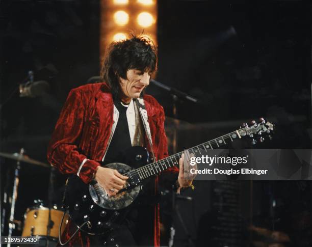English Rock musician Ronnie Wood, of the group the Rolling Stones, plays guitar as he performs onstage during the group's 'Voodoo Lounge Tour' at...