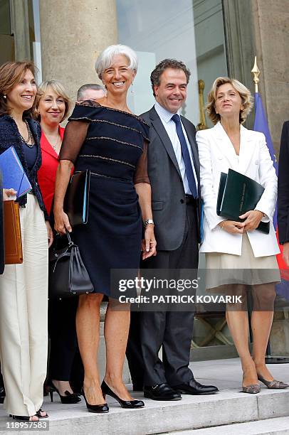 France's former Finance minister Christine Lagarde who was named the day before the first-ever female chief of the IMF, poses with her colleagues,...