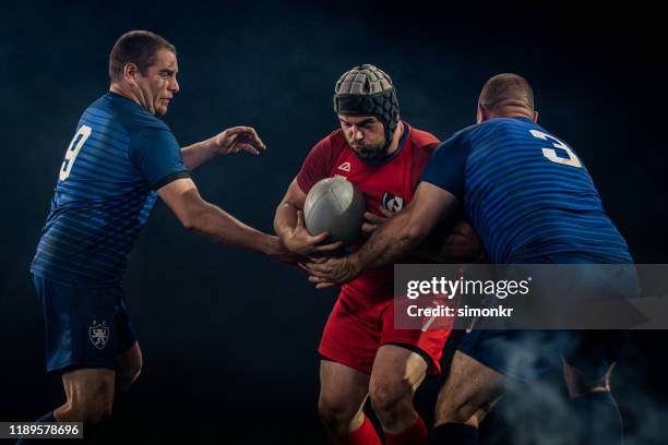 rugby players tackling his opponent - tackling stock pictures, royalty-free photos & images