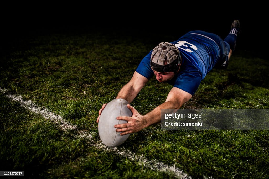 Rugby player scoring a goal