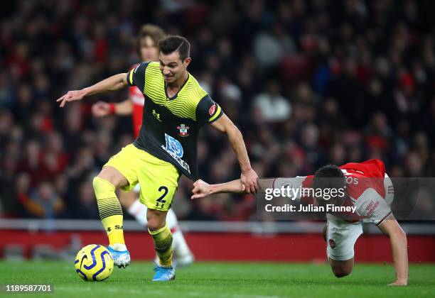 Sokratis Papastathopoulos of Arsenal fouls Cedric Soares of Southampton during the Premier League match between Arsenal FC and Southampton FC at...