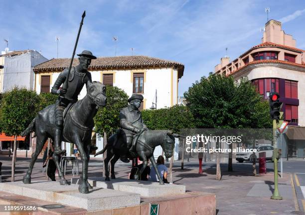 September 2019, Spain, Alcazar De San Juan: A sculpture by Don Quixote and Sancho Panza on the market square. The region served Miguel de Cervantes...