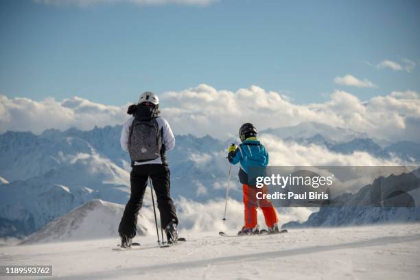 mother and son skiing enjoying winter season on top of ischgl  ski resort, austria/switzerland - skidsemester bildbanksfoton och bilder