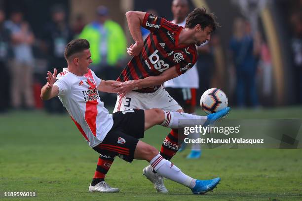 Rodrigo Caio of Flamengo fights for the ball with Rafael Santos Borre of River Plate during the final match of Copa CONMEBOL Libertadores 2019...