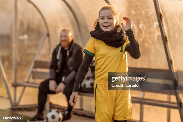 soccer father coaching football daughter during a game - parents sideline stock pictures, royalty-free photos & images