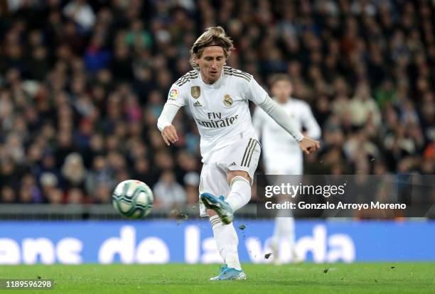 Luka Modric of Real Madrid scores his team's third goal during the La Liga match between Real Madrid CF and Real Sociedad at Estadio Santiago...