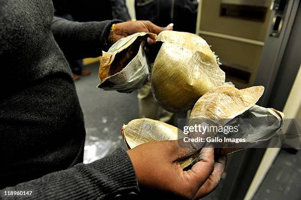 Police inspect the bra in which drugs were discovered on July 12, 2011 in Johannesburg, South Africa. 6 foreign nationals have been arrested at OR...