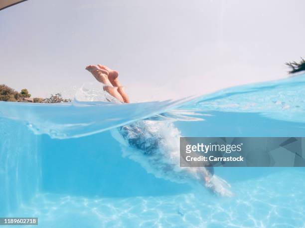 a man throws himself into the pool in summer. - full body bildbanksfoton och bilder