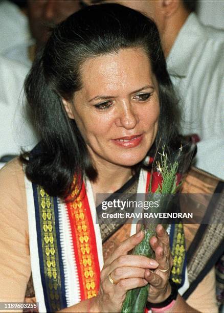 Indian opposition leader Sonia Gandhi thanks a supporter who offered her flowers after she was elected chairperson of the party's parliamentary wing...