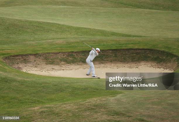 Fredrik Jacobson of Sweden plays a bunker shot during the final practice round during The Open Championship at Royal St. George's on July 13, 2011 in...