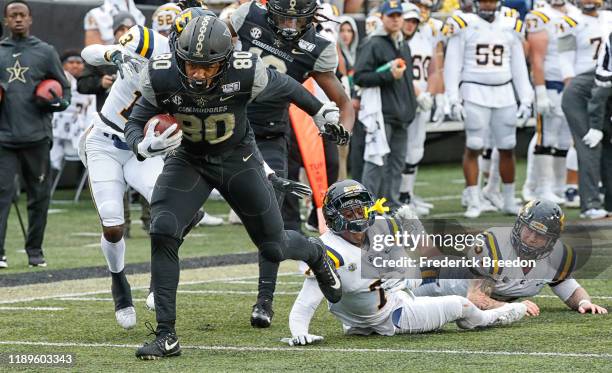 Tight end Jared Pinkney of the Vanderbilt Commodores breaks out of a tackle to score a touchdown against the East Tennessee State Buccaneers during...