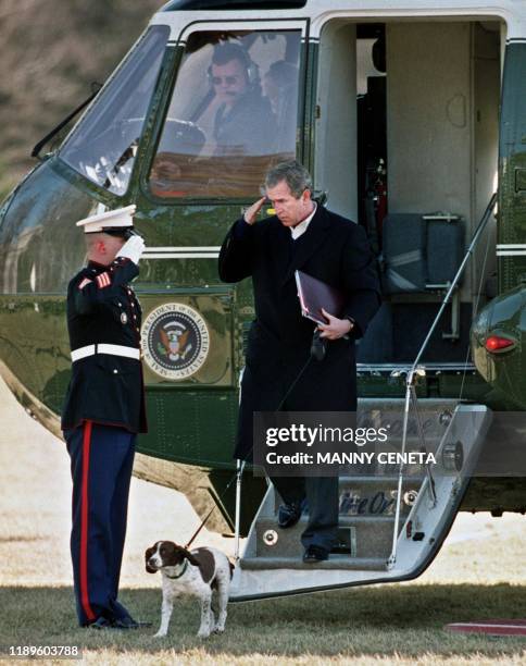 President George W. Bush arrives from the Camp David preidential retreat with pet dog "Spot" on the South Lawn of the White House 11 February 2001 in...