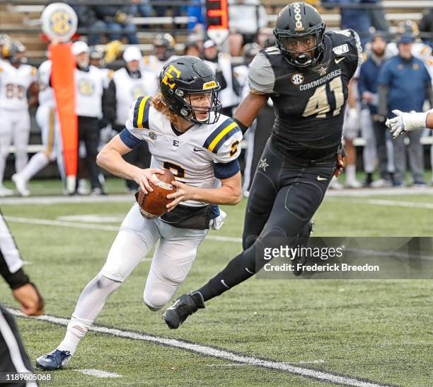 Quarterback Tyler Riddell of the East Tennessee State Buccaneers is chased by linebacker Elijah McAllister of the Vanderbilt Commodores the during...