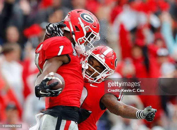 George Pickens of the Georgia Bulldogs reacts after pulling in a reception for a touchdown against the Texas A&M Aggies with Kearis Jackson in the...