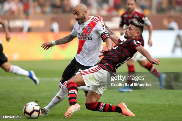 Javier Pinola of River Plate fights for the ball with Giorgian De Arrascaeta of Flamengo during the final match of Copa CONMEBOL Libertadores 2019...