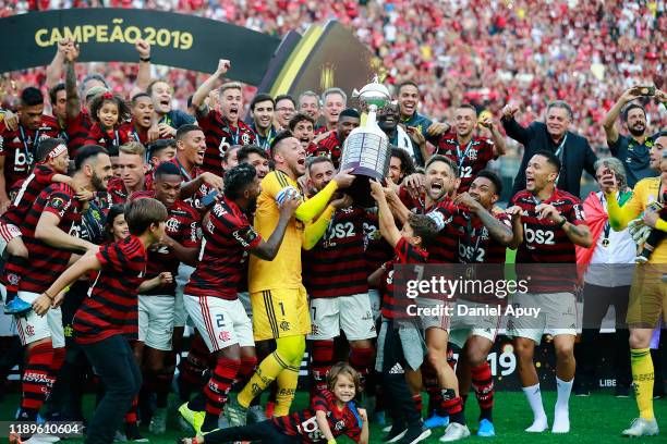 Diego Alves, Everton Ribeiro and Diego of Flamengo lift the trophy after winning the final match of Copa CONMEBOL Libertadores 2019 between Flamengo...