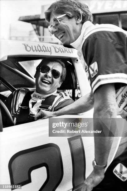 Driver Buddy Baker talks with car owner Leonard Wood during a practice session for the 1984 Daytona 500 on February 18, 1984 at the Daytona...