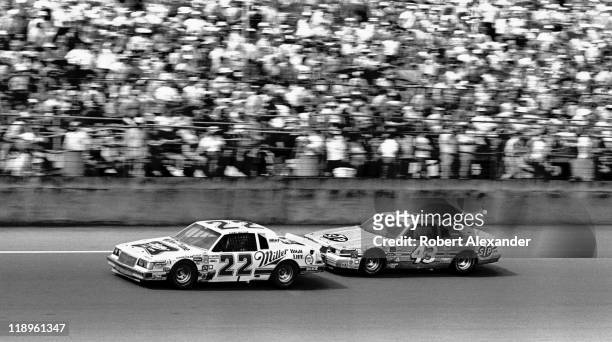 Driver Bobby Allison leads Richard Petty as they drive past the Daytona International Speedway grandstands during the 1987 Daytona 500 on February...