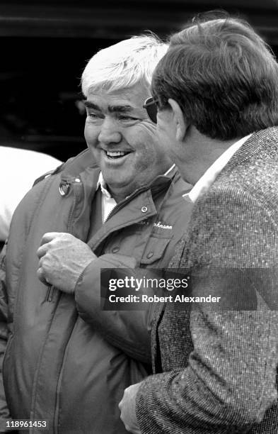 Car owner Junior Johnson, left, talks with NASCAR CEO Bill France Jr. In the Daytona International Speedway garage area prior to the start of the...