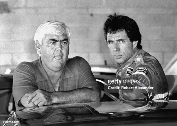 Driver Darrell Waltrip, right, talks with car owner Junior Johnson in the Daytona International Speedway garage prior to the start of the 1986...