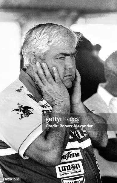 Car owner Junior Johnson covers his ears in the Daytona International Speedway garage during a practice session for the 1984 Daytona 500 on February...