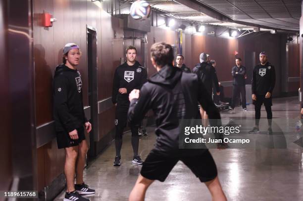 Members of the Los Angeles Kings juggle a soccer ball while warming up outside the Kings locker room before the game against the Arizona Coyotes at...