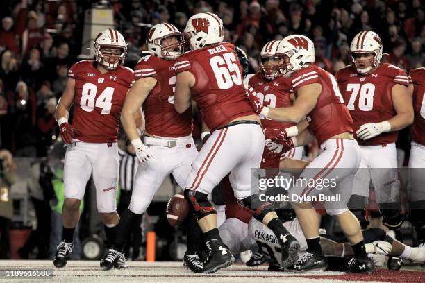 Mason Stokke of the Wisconsin Badgers celebrates with teammates after scoring a touchdown in the fourth quarter against the Purdue Boilermakers at...