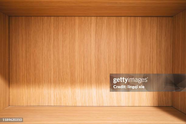 interior of wooden cabinet under light - kitchen cabinet stock pictures, royalty-free photos & images