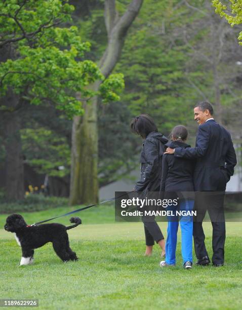 President Barack Obama , First Lady Michelle Obama and their daughter Malia walk with the new family puppy Bo, a Portuguese water dog, April 14, 2009...